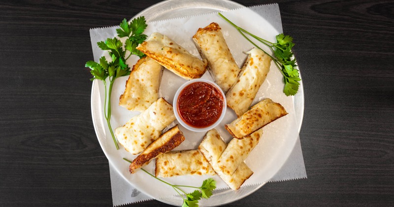 Cheesy bread served with red sauce
