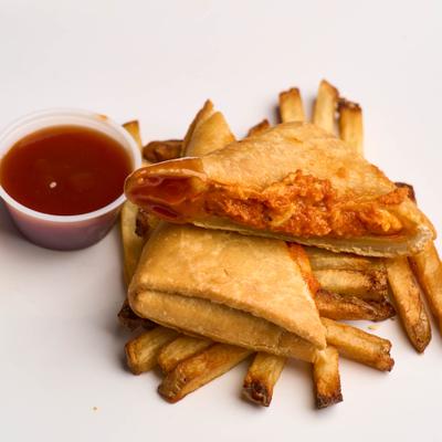 Pizza puff with fries and dip.