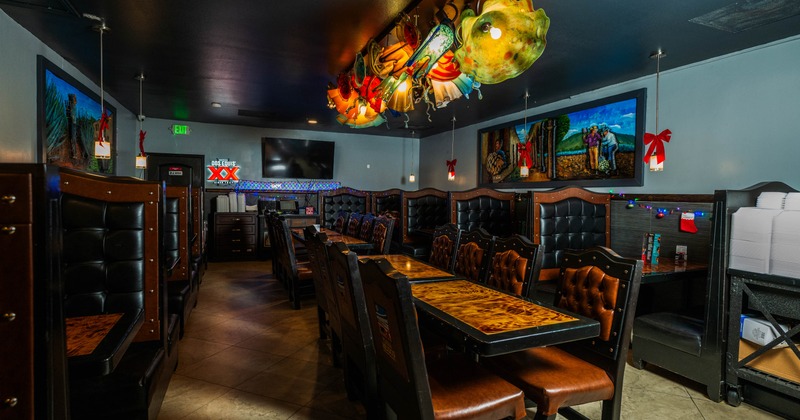 Interior, wooden tables, leather chairs, a colorful glass light fixture, a mural