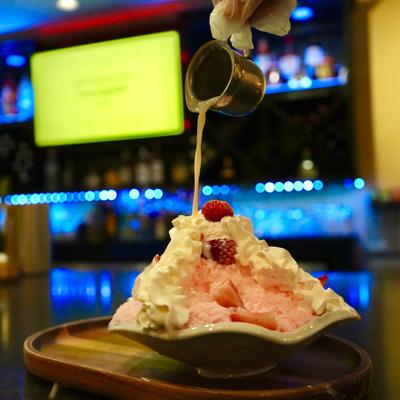 Strawberry milk ice with fresh strawberries, whipped cream, and strawberry puree.