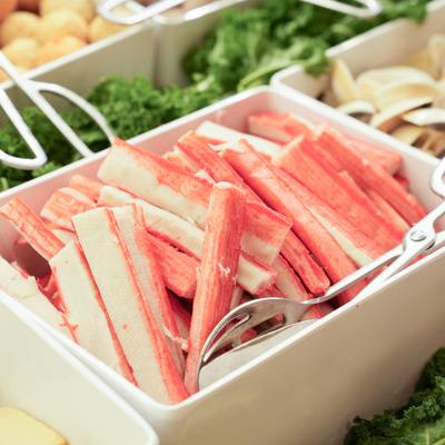 Imitation crab sticks at the buffet-style spread of fresh ingredients.