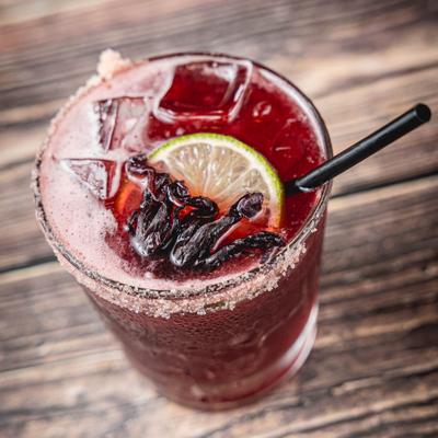 Salt rimed lowball glass with Hibiscus Rita cocktail.