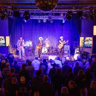Live music performance before a standing crowd.