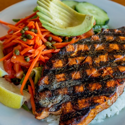 Grilled fish steak with rice and avocado.