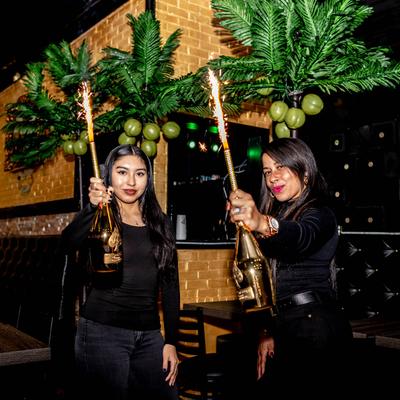 Guests with Champagne bottles and sprinklers.