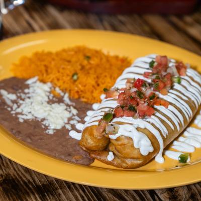 Crispy chimichanga, with sour cream, tomato salsa, rice, and beans.