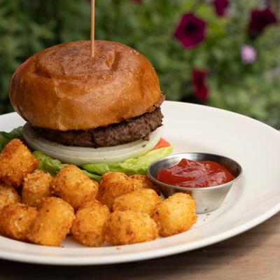 California Burger served with tater tots and a dipping sauce.