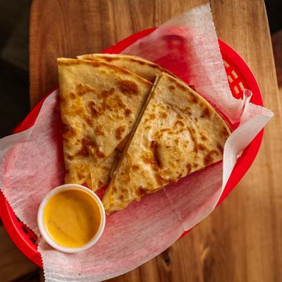 Cheese quesadilla with dip, top view.