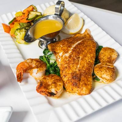 Seasoned seabass fillet, shrimp, butter, and veggies.