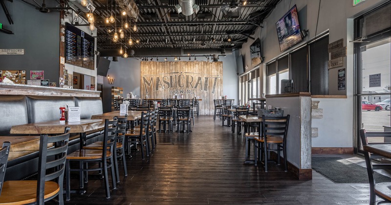 Interior, open space dining area, long banquette bench with tables and chairs