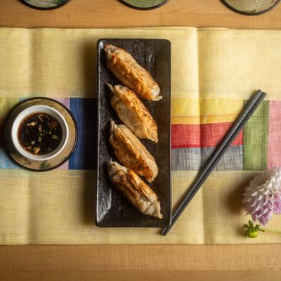 Portion of dumplings served with dipping sauce.