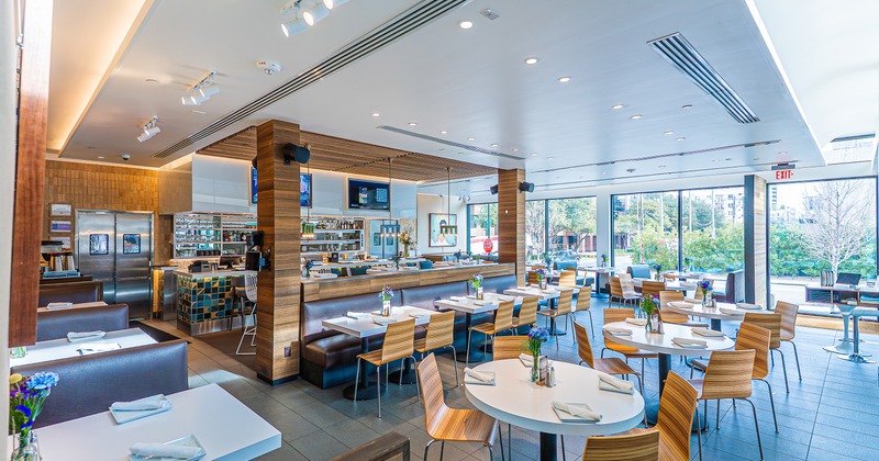 Spacious, modern and cozy interior dining area with set dining tables