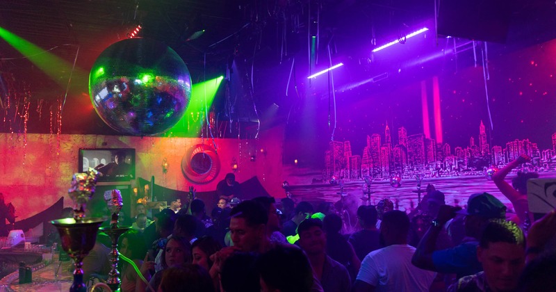 Interior full of guests with Hookahs and disco balls