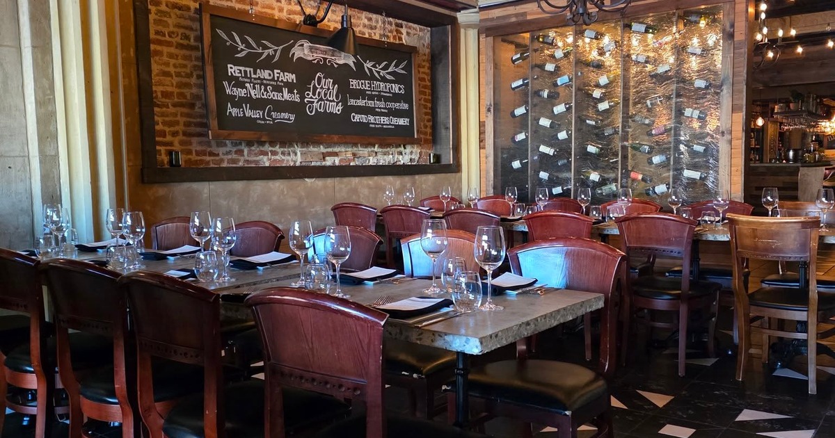 Dining tables and a wine rack in the background
