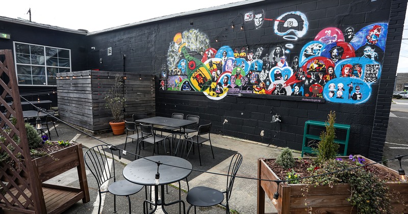 Patio with tables and chairs, wall mural