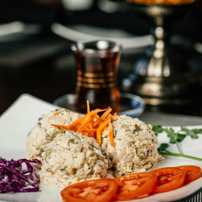Potato and chicken salad, with tomato, purple cabbage, and carrots.