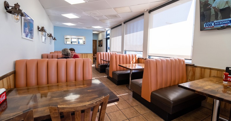 Diner interior with tan leather booths and wooden tables