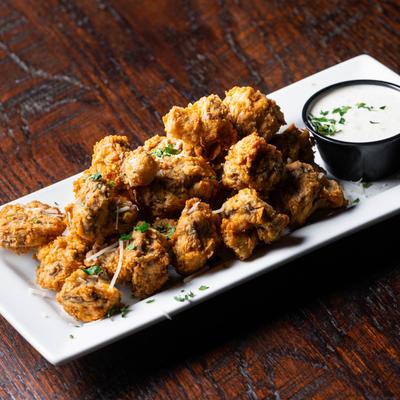Fried mushrooms served with a ranch sauce for dipping.