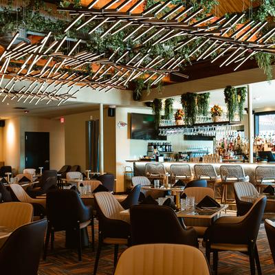 The interior of the restaurant, tables and chairs.