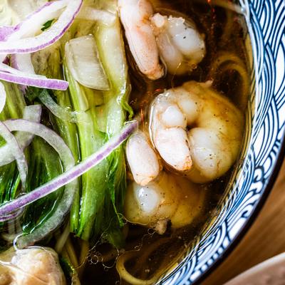 Wonton pho with shrimp, served, top view, closeup