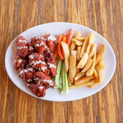 Sriracha Buffalo Chicken Wings served with carrots, celery, and fries.