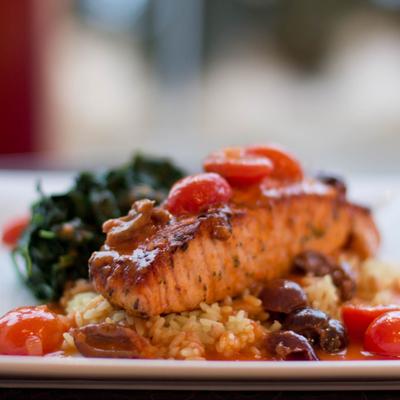 Salmon with olives, cherry tomato, rice and spinach.