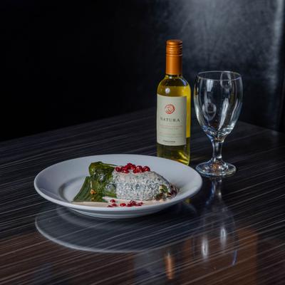 Stuffed poblano pepper served with white wine.