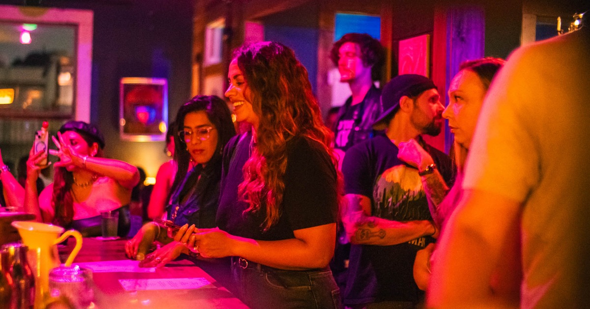 Lively bar scene with a group of people interacting