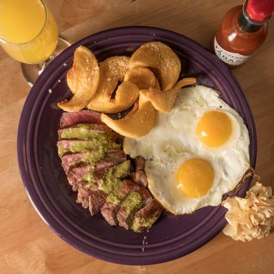 A top view of eggs and steak.
