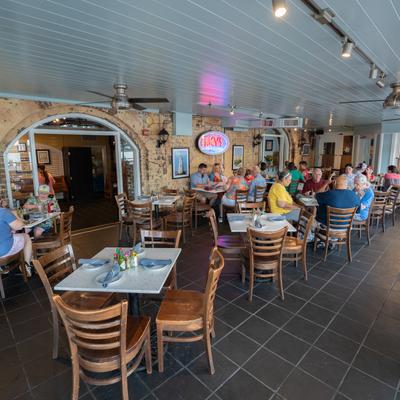 Diner area, tables, chairs, wide view.