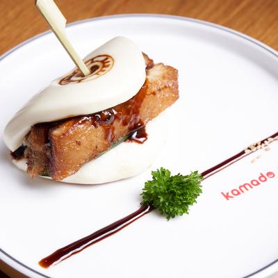 Steamed bun filled with pork belly and cucumber.