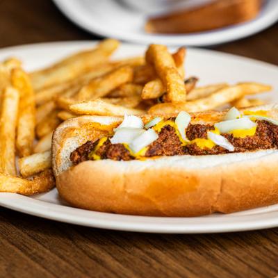 Chili hot dog with fries.