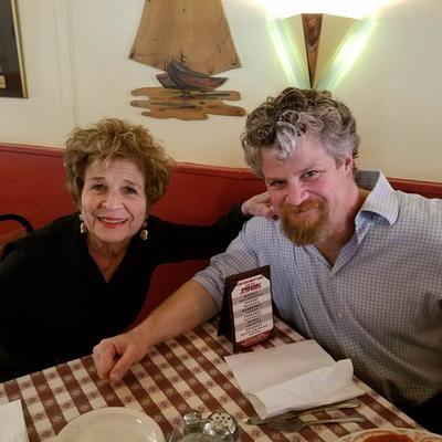 Two people smiling at the camera.