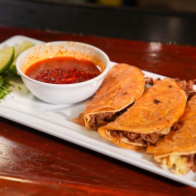 Birria tacos, with consomme.