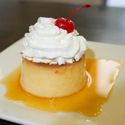 Mexican Flan topped with whipped cream.