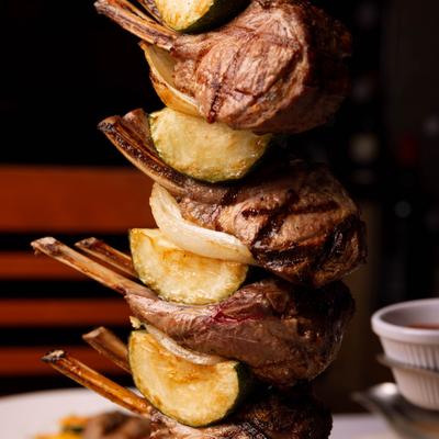 Vertical lamb skewer and zucchini skewer.