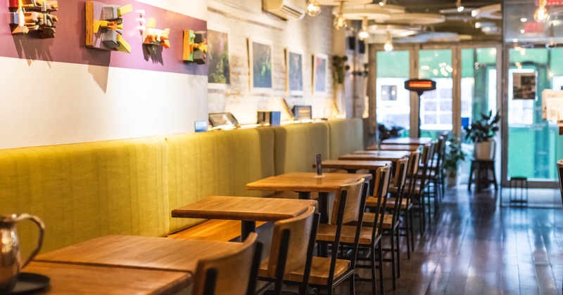 Interior, seating area with banquette seating, tables and chairs