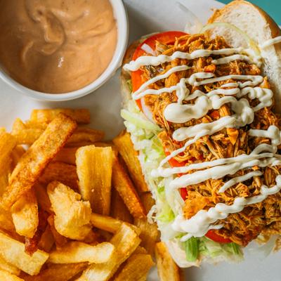 Pulled chicken sandwich with yuca fries and remoulade sauce.