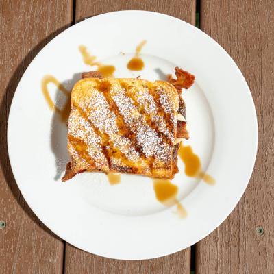 French toast sandwich with bacon, butter, and syrup.