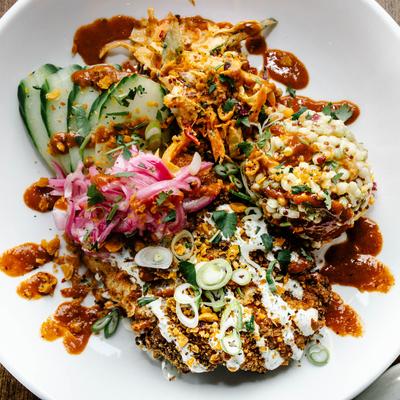 Tikka masala bowl, pickled red onions, cous cous salad, chili roasted chickpeas, mint cilantro yogurt and cucumbers.