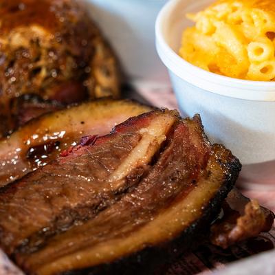 Brisket and pulled pork served with cornbread and mac and cheese on the side.