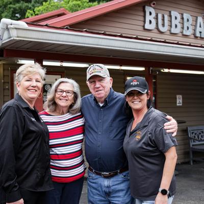 People posing outside of the restaurant.