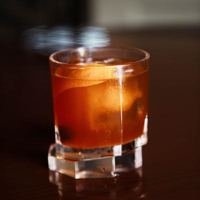 Old Fashioned cocktail with an orange peel.