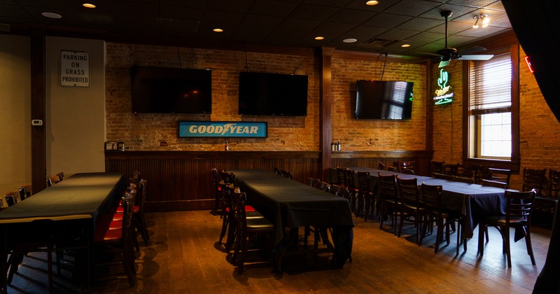 Diner area, tables, chairs, tv's above