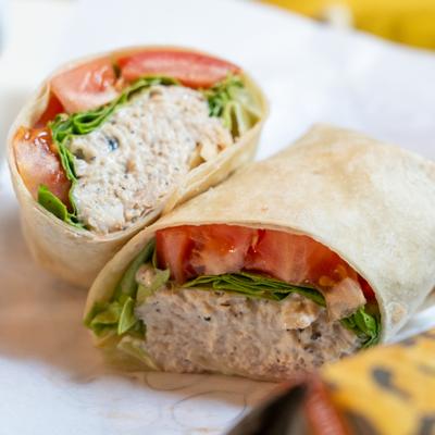 Chicken salad wrap with lettuce and tomatoes.