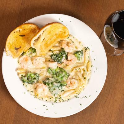 Shrimp Alfredo Penne Pasta, with broccoli, and toast.