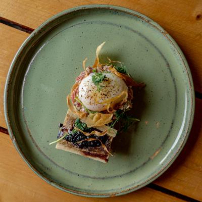 Bone Marrow and Beef Tartare topped with a soft-boiled egg.