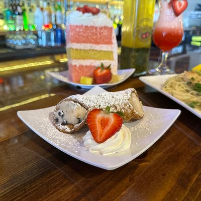 Cannoli, with whipped cream, and strawberry.