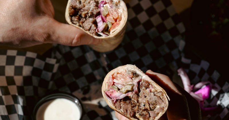 Steak Shawarma served with red onion and tahini sauce on the side