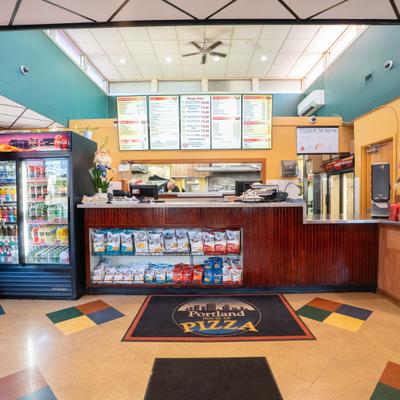 Interior with ordering counter and menu board above it.